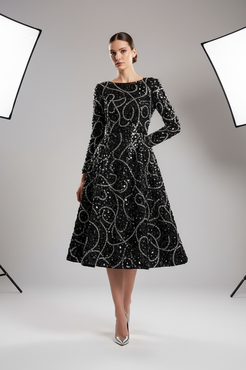 Knee-length black gown with long sleeves and shiny glittering stone embellishments